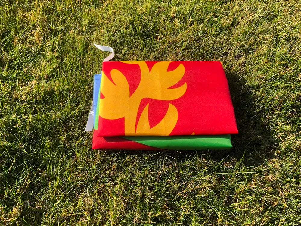 Colorful flag with floral design on grass