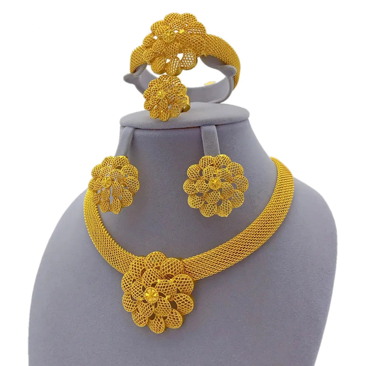 Gold floral jewelry set on a gray mannequin bust