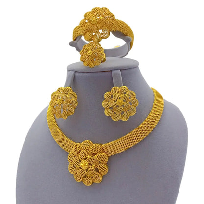 Gold floral jewelry set on a gray mannequin bust