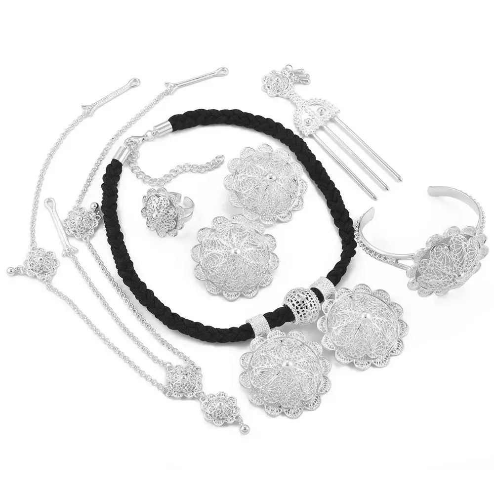 Silver floral jewelry set with black cord on a white background
