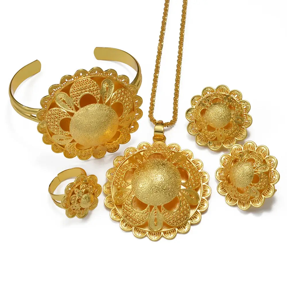 Gold jewelry set including necklace, earrings, and rings on a white background