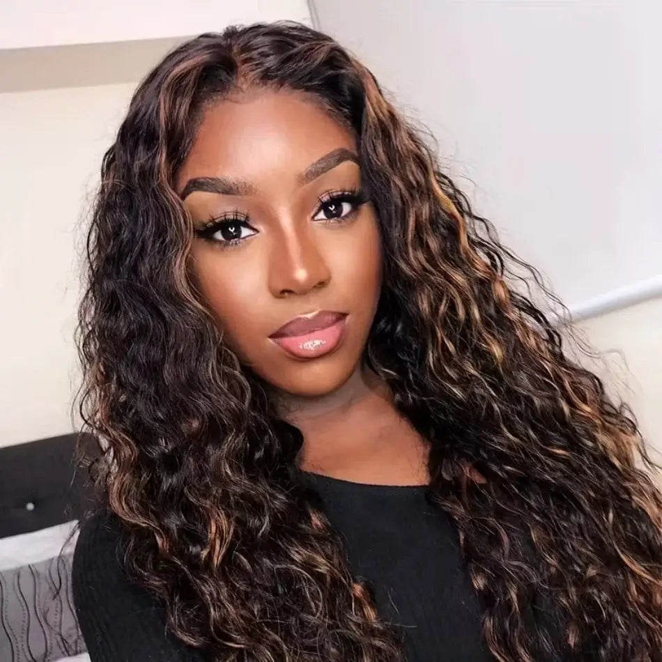 Woman with long, wavy hair wearing a black top.