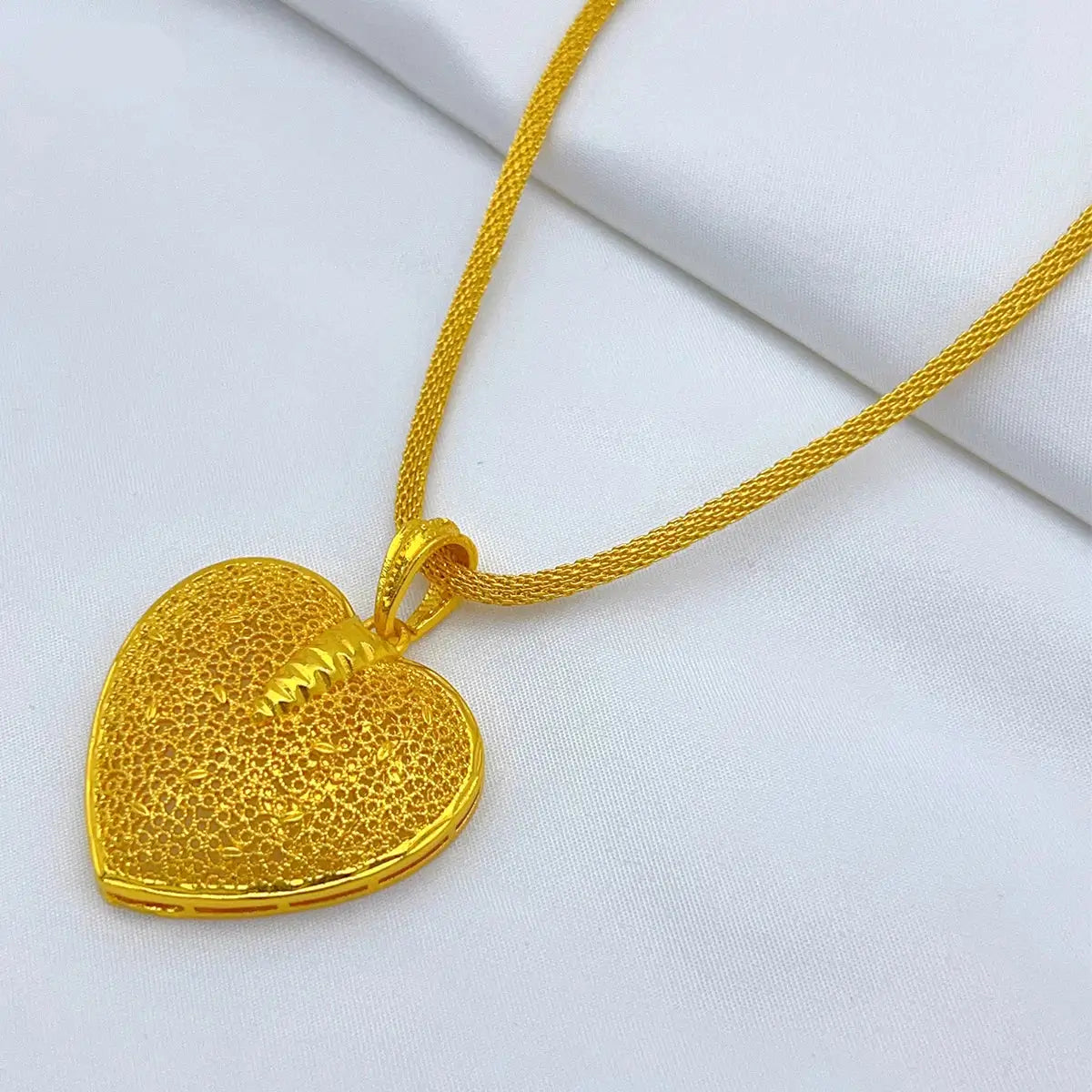 Gold heart-shaped pendant on a white background