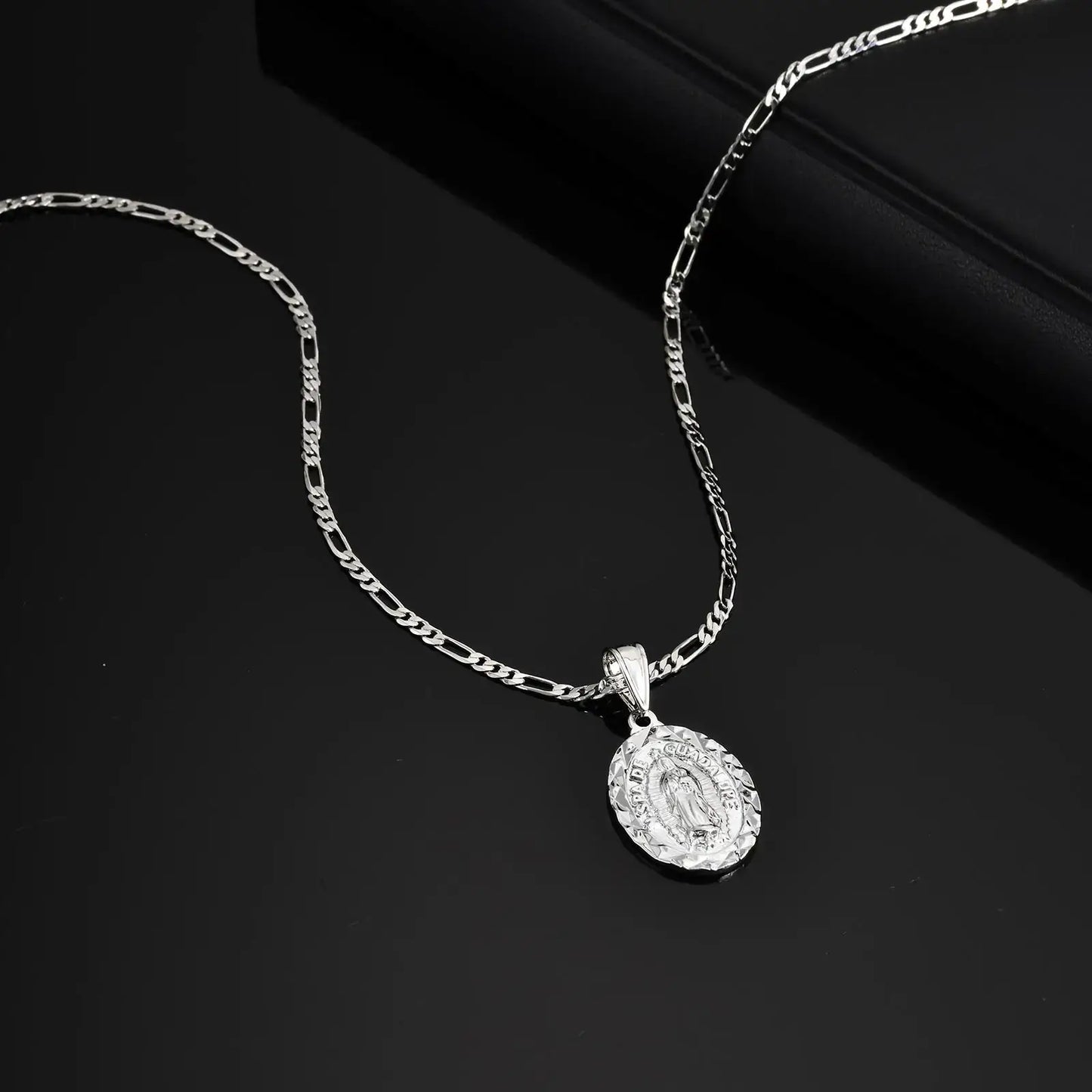 Silver necklace with a pendant on a dark background