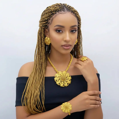 Woman wearing gold jewelry against a light gray background