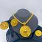 Gold necklace and earrings set on a gray stand with a white background