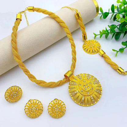 Gold jewelry set with necklace, earrings, and pendant on a white background