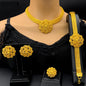 Gold jewelry set including necklace, earrings, and bracelet on a mannequin with a black top.