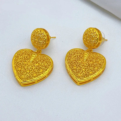 Gold heart-shaped earrings on a white background