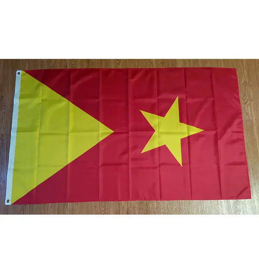 Red flag with a yellow star and triangle on a wooden surface