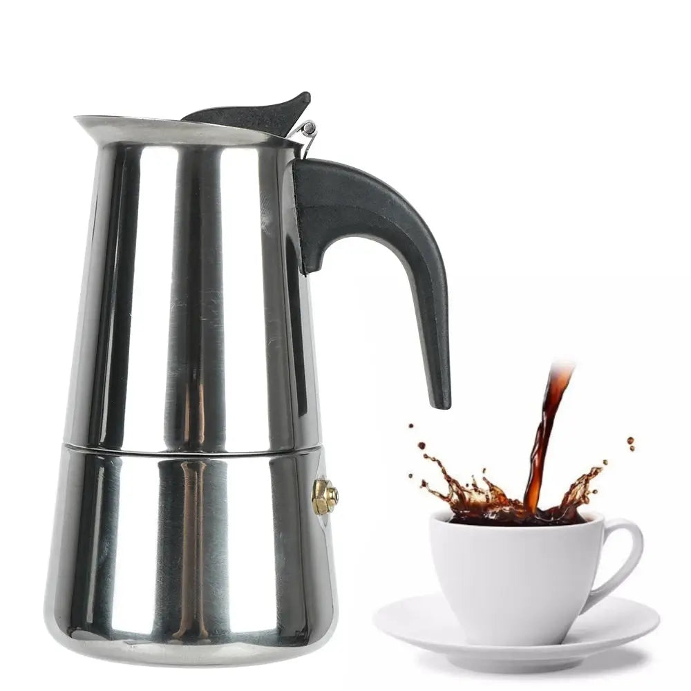 Stainless steel espresso maker with a cup of coffee being poured into it on a white background