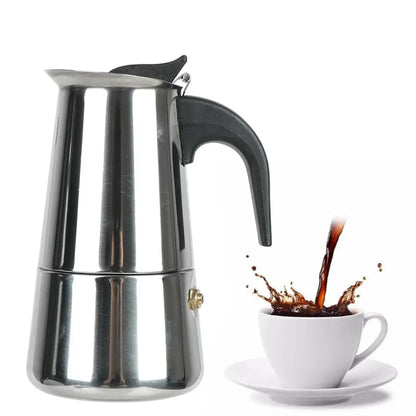 Stainless steel espresso maker with a cup of coffee being poured into it on a white background